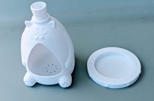 This cute 3D printed Fancy Cat planter is perfect for any weather, indoors and outdoors alike! Show off your cat's personality by painting the ears, whiskers, and paws with simple acrylic paint. It is a self-watering planter where you pour the water in the top of the hat and the plant can drink from the removable base of the planter. It is great if you are going away for a trip or just for normal use. This product is made from very durable PLA material which is a bio-degradable plastic that is safe for the environment. There are two pieces to this product: The cat body and the base which are used to store the water. The total height is 7.5 inches. Please choose the color you would like from the drop-down menu options.